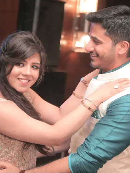 A close-up of the couple sharing an intimate moment during their engagement celebration. Their smiles show their deep affection for one another.