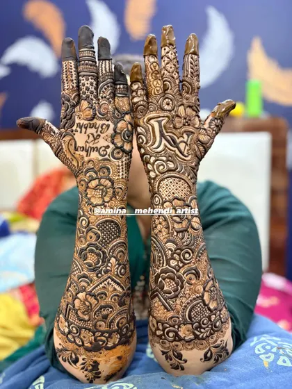 A fun bridal design with 'Dulhan ki Bhabhi' (Groom's sister-in-law) written on one hand, showing that mehendi is for the whole family to enjoy.