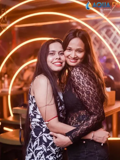 Two friends enjoying a hug and the great music.
