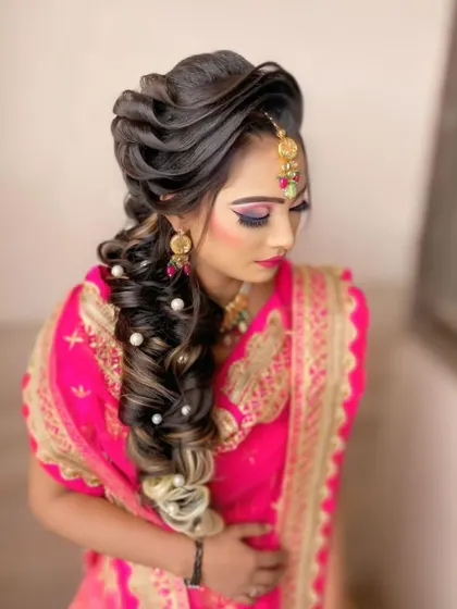 This is another variation of the popular reception braid, with carefully placed pearls and highlights that catch the light. It's a perfect blend of traditional and modern hairstyling.