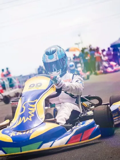 A vibrant, artistic shot of our driver in the number 99 kart during the RMC R3.