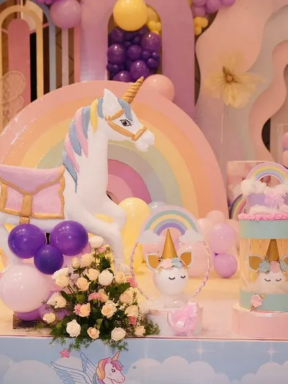 More details from the unicorn stage, including a large carousel unicorn, rainbow props, and pastel balloon arrangements. I love creating these immersive, picture perfect settings.