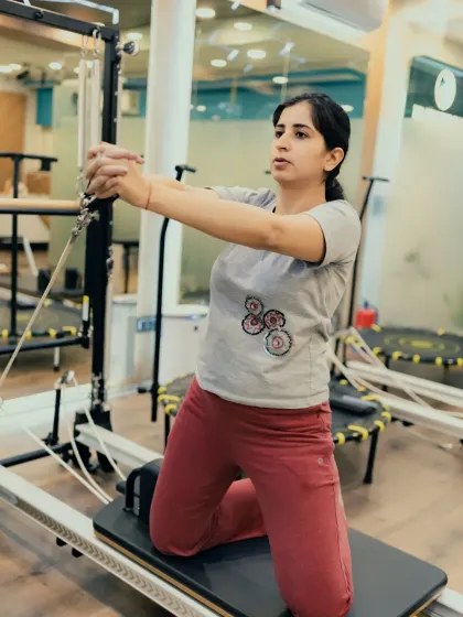 This kneeling chest press on the Reformer requires significant core engagement to keep the torso stable against the resistance of the springs. It's a great upper body and core workout.