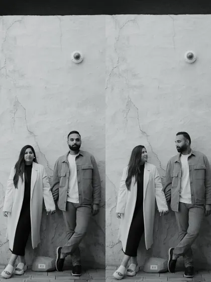 A modern, stylish black and white portrait of a couple in Dubai. The clean background and their confident poses create a very chic and contemporary image.