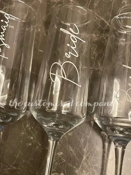 Cheers to the bride and her bridesmaids. These elegant champagne glasses are individually personalized, making them a perfect keepsake for your bachelorette party or getting-ready toast.