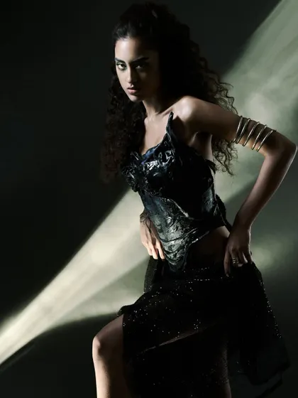 Using a projector to create a "ray of light" effect. This technique adds a graphic, cinematic element to this dark and moody studio portrait.