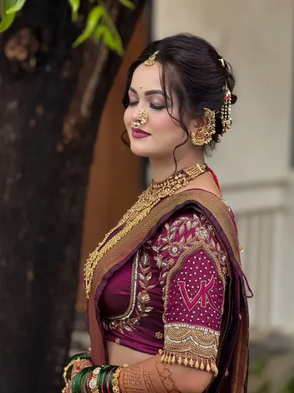 The side profile shows how the Navari drape complements the embroidered blouse and hairstyle. Every detail is considered to create a cohesive and stunning bridal appearance.