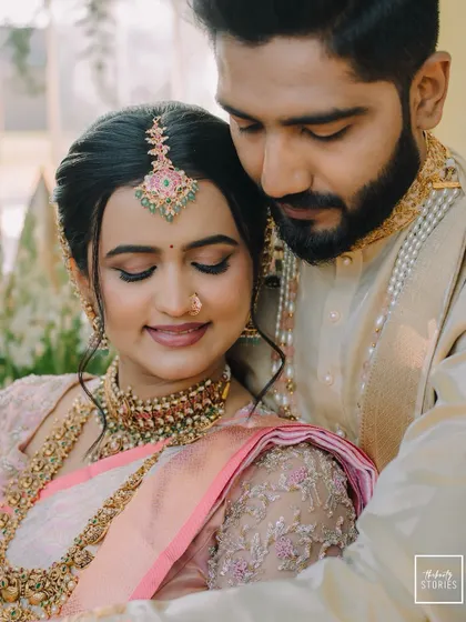 A soft and romantic close-up of the couple. The bride's gentle smile and the groom's loving gaze create a portrait filled with warmth and affection.