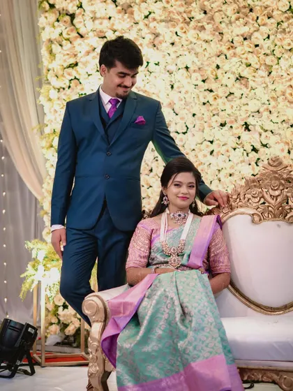 Janani at her reception, wearing a unique pastel green and pink saree. The makeup features a pop of pink on the eyes to tie the look together.
