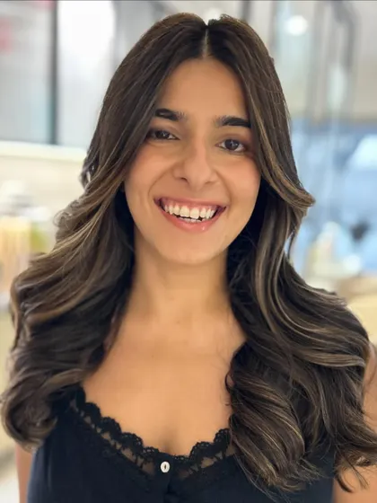 A two-tone balayage on a natural dark brown base. The lighter pieces around the face create a beautiful face-framing effect and a very happy client.