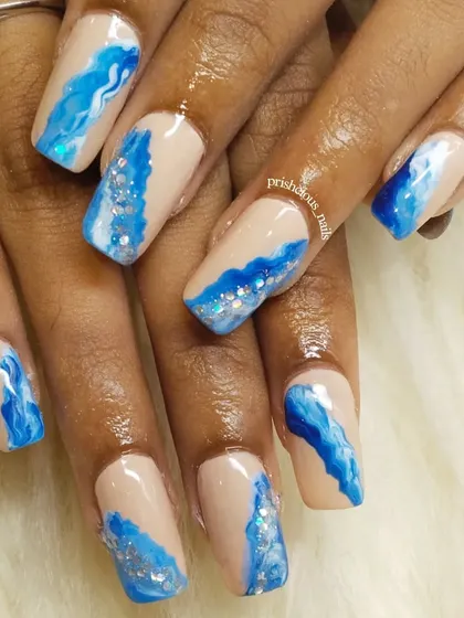 Another angle of the ocean wave nails, showing the depth and movement in the hand-painted art. Perfect for a beach vacation.