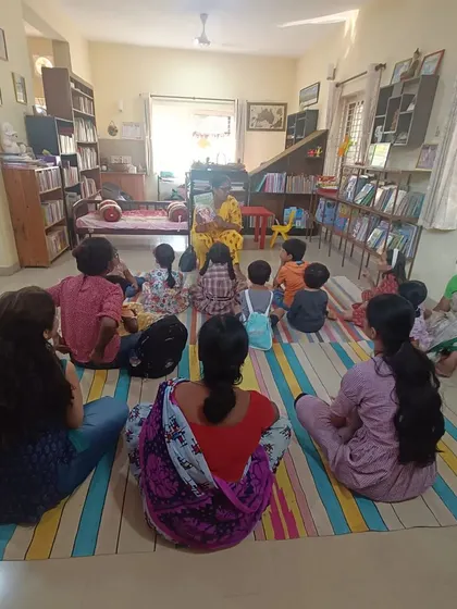 A similar wide view that emphasizes the community of parents and children enjoying the story together.