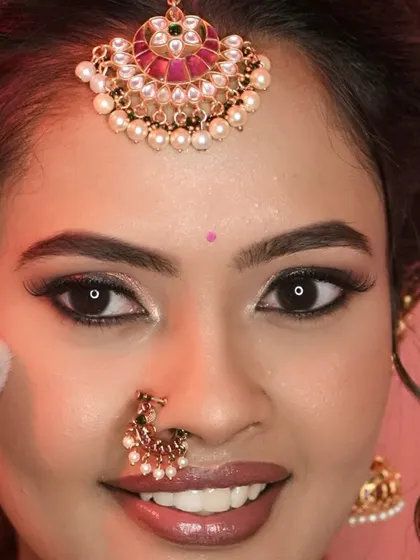 A close-up showing the final touch of powder. This step is crucial for setting the makeup and ensuring a long-lasting, flawless finish.