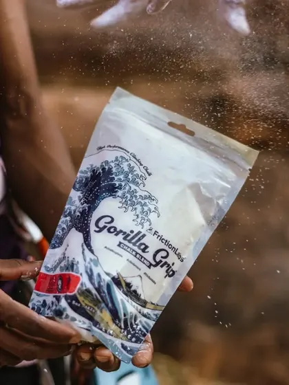 A participant holds a bag of high-performance climbing chalk. We believe having good gear enhances the experience and helps build confidence.