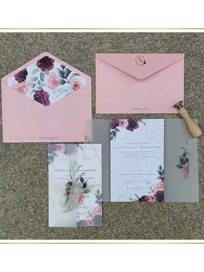 This design pairs the softness of blush pink with the richness of burgundy. The floral illustrations on the vellum wrap and envelope liner create a romantic and cohesive look, perfect for a modern wedding.