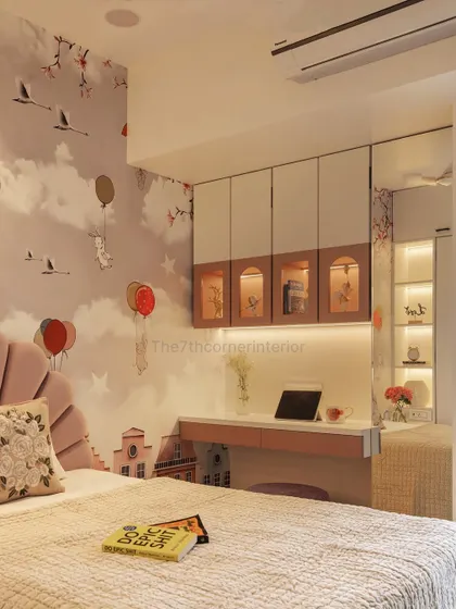 A view of the integrated study area in the kids' room. The overhead cabinets feature charming arched glass doors, providing storage that is both functional and decorative.
