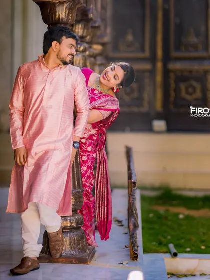 A playful and romantic moment between a couple in a beautiful heritage setting. The bride's expression and the groom's loving gaze are perfectly captured.