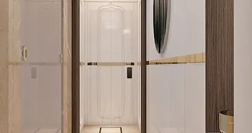 A closer look at the grand entrance foyer, showing the intricate traditional motif outlined on the main door. This detail adds a personal and cultural touch to the modern design.