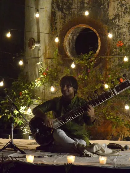 Performing at the Alembic Dhrupad Foundation in Baroda. The beautiful outdoor setting with rustic walls and string lights created a magical ambiance for our evening concert.