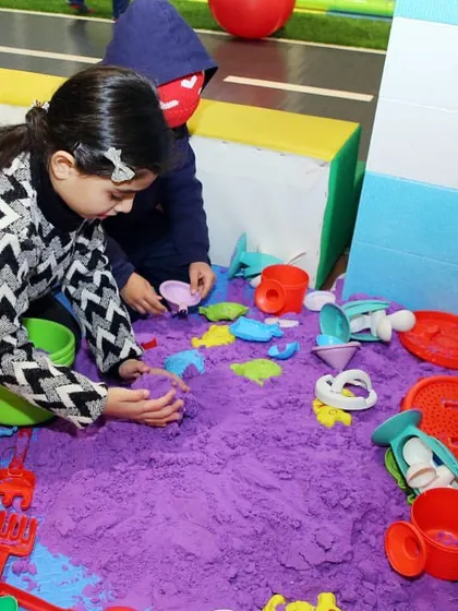 A sand play area provides a great sensory activity for younger guests. Even at a superhero party, it's important to have a variety of games for kids of all ages.