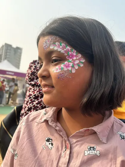 So much joy in this photo! Her smile is as bright as the glittery flowers I painted on her face.