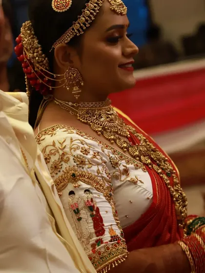 A side view of the bride and groom-themed blouse, showing how the embroidered figures on the sleeve add a personal narrative to the wedding attire. The groom is seen waiting for his bride.
