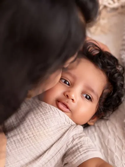 A quiet moment with a 100-day-old baby looking right at the camera. This shot captures that stage when they start to become more aware and show their budding personality.