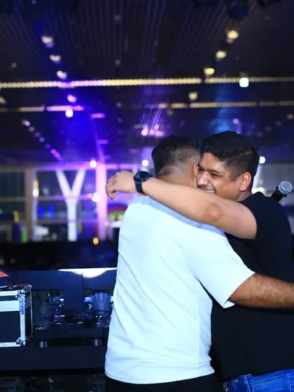 Sharing a hug on stage after a successful set. The energy and appreciation from the crowd and the event team make it all worthwhile.