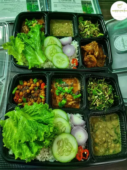 A side-by-side look at my veg and chicken thalis. Both are loaded with different items, offering a complete meal with fresh salad, rice, and multiple curries.