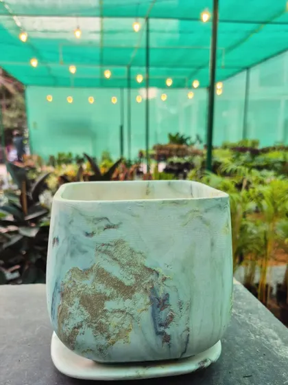 This square-shaped pot has a beautiful blue and gold marble finish, resembling a piece of natural stone. It's a unique and artistic choice for your indoor plant styling.