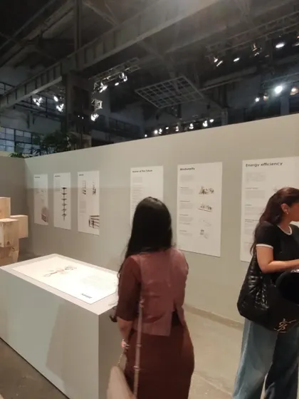 Visitors interacting with my exhibit at the Godrej Conscious Collective. The display panels explain the principles of my hybrid timber system, from circularity and sourcing of materials to energy efficiency.