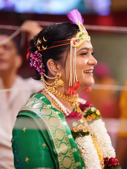 A candid moment of joy during the wedding ceremony. The bride's makeup remains flawless even in her happiest moments, showcasing its durability and natural finish.