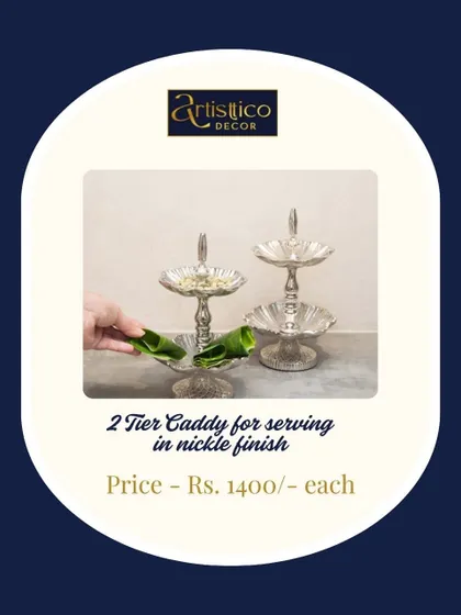 This two-tier caddy in a nickel finish is an elegant and practical piece for serving small bites or paan at a wedding. Its classic design fits beautifully with any decor style.