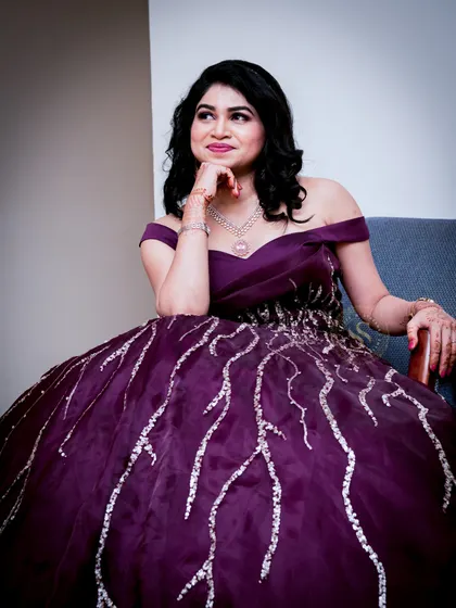 A thoughtful solo portrait of the bride-to-be, seated comfortably. We take time to capture individual portraits that highlight the person's personality and style during the event.