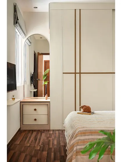 To save space in this master bedroom, I designed a dresser with a pull-out pouf that tucks neatly into the unit. The hollow center of the pouf creates space for the drawers, making it a compact and unified ensemble.