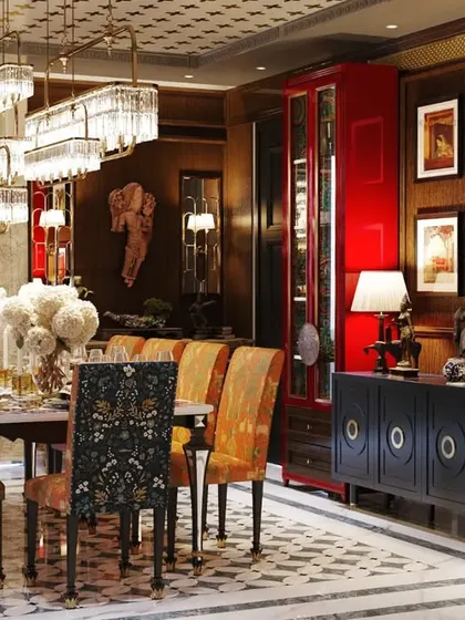 Our "jewel box" project was designed to impress from the moment you enter. The dining room features a rich color palette, intricate brass flooring inlay, and a collection of art, creating a luxurious, traditional, and Vastu-compliant space.