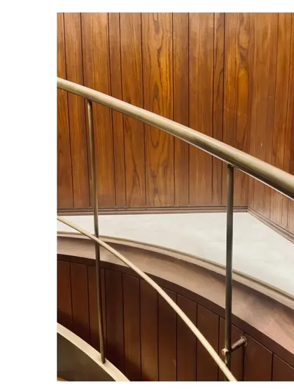 A detail of a spiral staircase handrail, crafted from aged brass with a beautiful patina. The hand must fit the rail, must fit the stringer, must fit the space. It is a satisfying process of getting every detail just right.