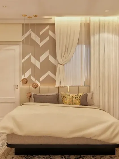 This bedroom features a striking accent wall with a geometric chevron pattern behind the bed. The custom wardrobe with fluted details and gold accents continues the theme of elegance and texture.