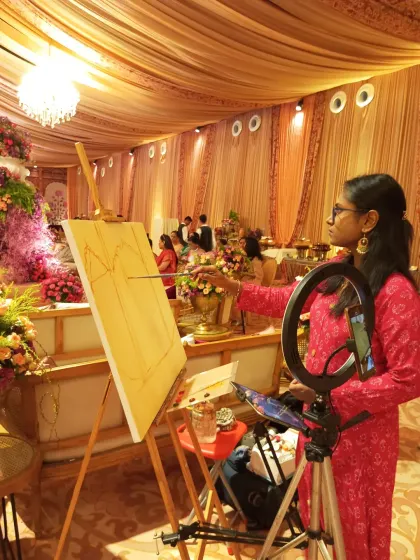 Here I am at the Taj Palace in Delhi, starting with the initial sketch of the magnificent mandap. My setup includes a ring light to ensure perfect lighting on the canvas, no matter the venue's ambiance.