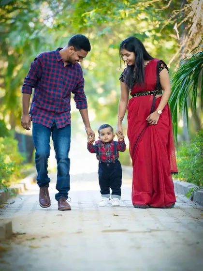 The whole family taking their little one for a walk. This is a beautiful way to symbolize their journey together as a family.