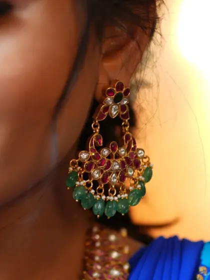 Another angle of the Jadau Chandbaali earrings, showing the delicate floral and peacock motifs.