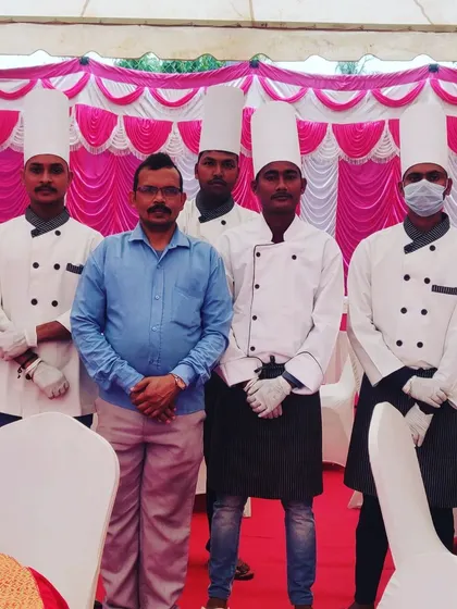 A group photo of the Sukhdev Caterers team, showcasing our professional attire including chef hats, coats, and gloves.