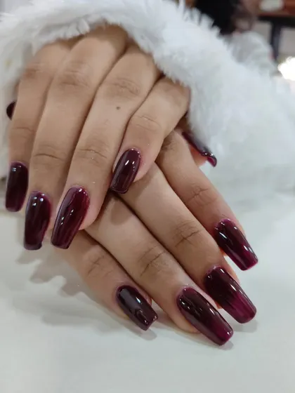 Your nails are a canvas. This deep wine, glossy manicure is perfect for making a statement, whether at a festive event or in the boardroom. It’s a sophisticated and confident look, like the perfect red lipstick for your hands.