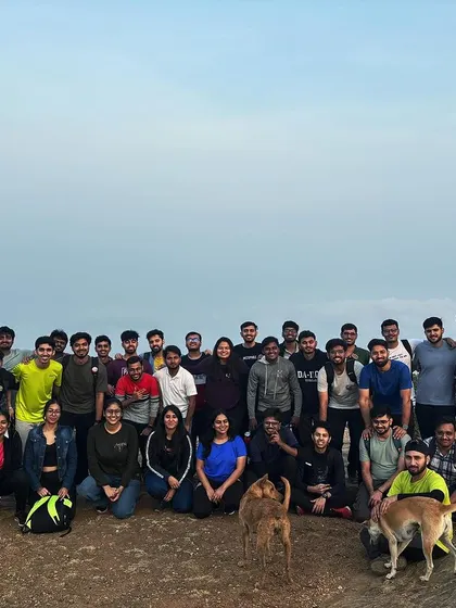 A large corporate group, including some friendly local dogs, at the summit. Our treks are about creating a positive and inclusive atmosphere.