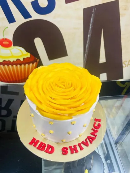 A 1kg cake topped with a beautiful, large mango rosette, perfect for a summer birthday.