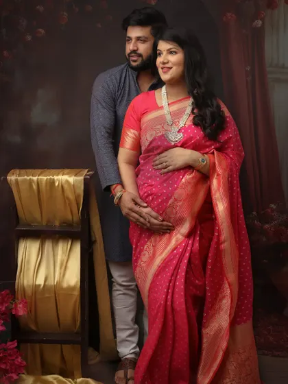 The vibrant pink of this Banarasi saree is simply breathtaking. I posed this couple to create a classic portrait that feels both traditional and full of love and anticipation.