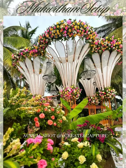 A lush Muhurtham setup featuring modern arched structures adorned with dense pastel florals and elegant chandeliers, blending contemporary design with classic romance.