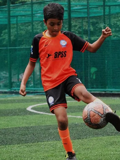 This young player from our U-9 team demonstrates great ball control. My training focuses on mastering these fundamental skills early, which builds confidence and prepares them for more advanced play.
