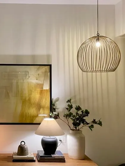 A quiet evening moment at home. The play of light and shadow from different lamps creates a warm and cozy atmosphere.