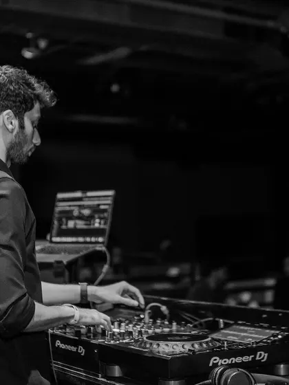 A side profile shot in black and white, focused on my hands on the mixer at Sunburn.